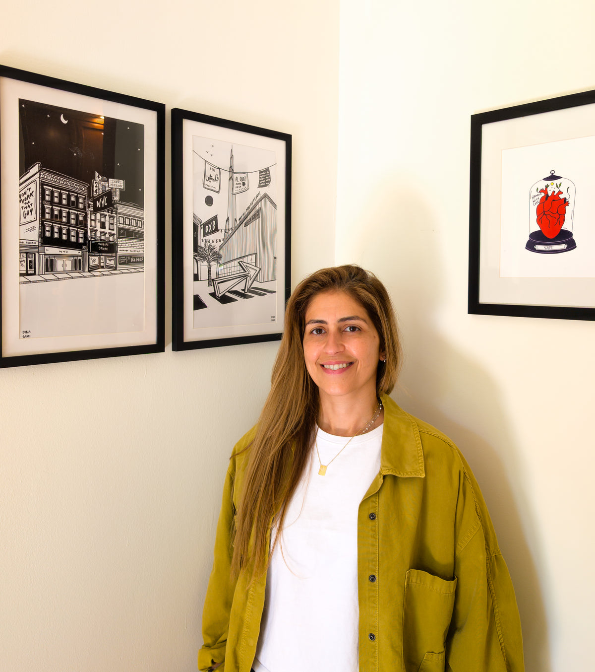Dina Sami beside her framed work