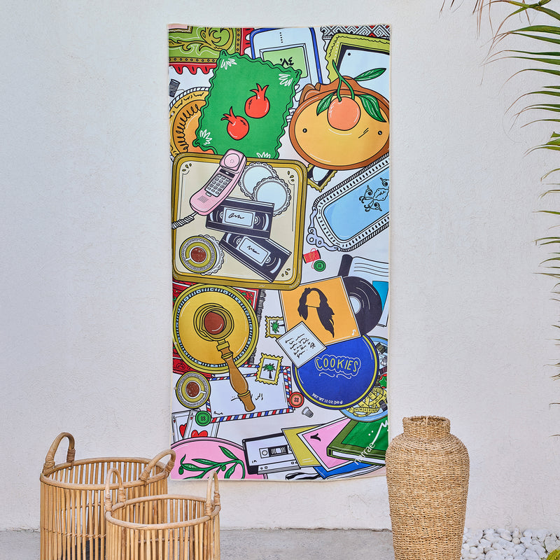 Grandma's House art beach towel by Dina Sami, cookie tins, letters and a coffee tray, hanging on a wall