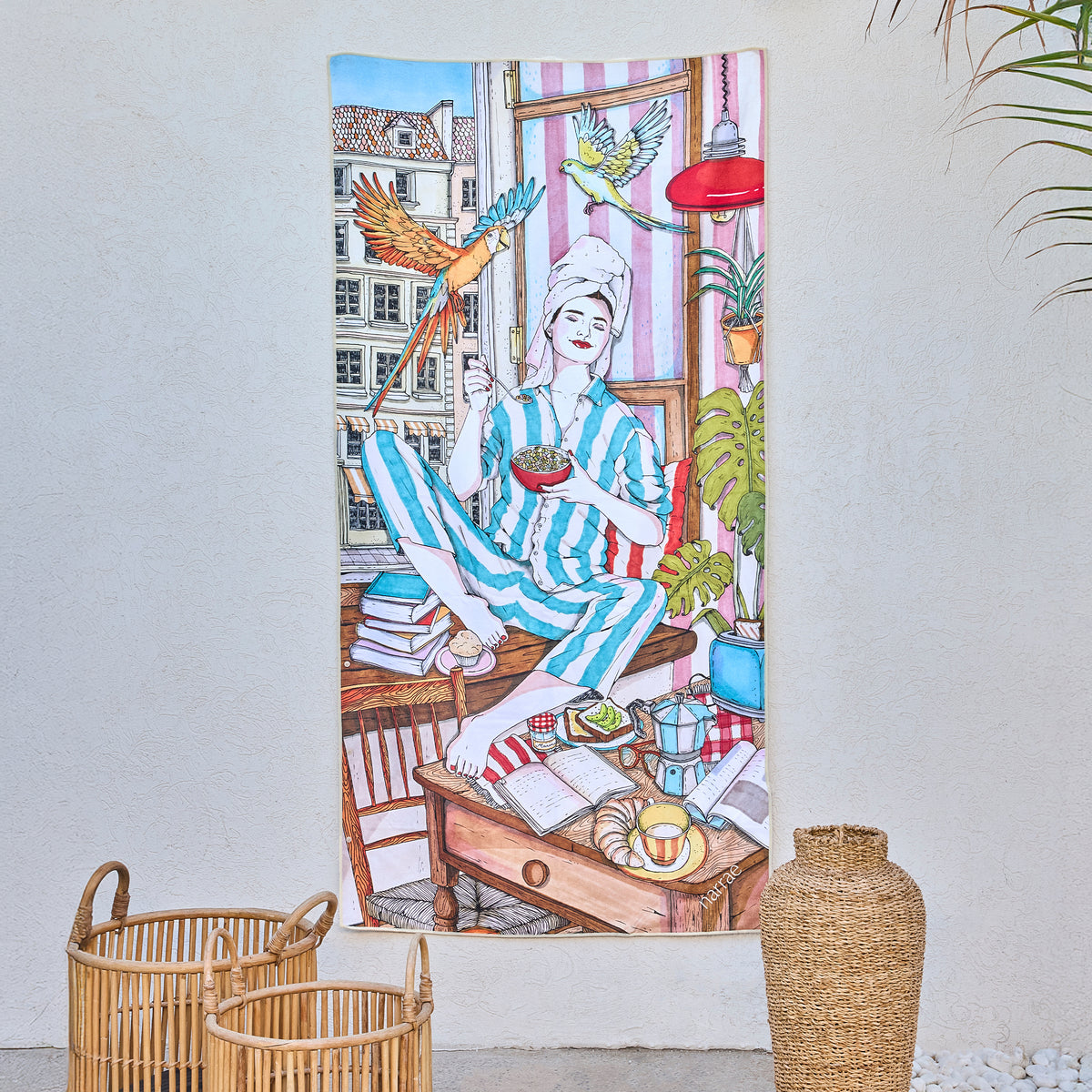 Me Time art beach towel by Ana Jarén, a woman in striped pyjamas with parrots, hanging on a wall