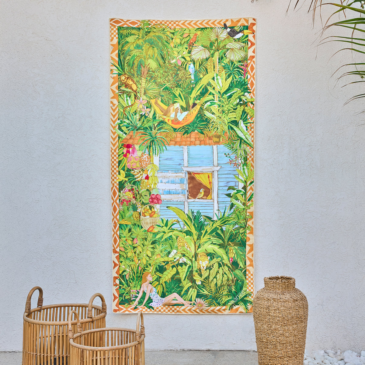Saudade art beach towel by Gabriel Azevedo, a leafy jungle scene with a window, hanging on a white wall