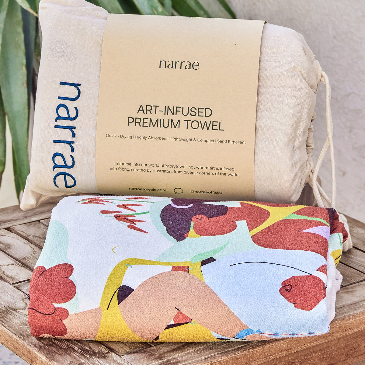 Friendship beach towel folded with its Narrae drawstring bag