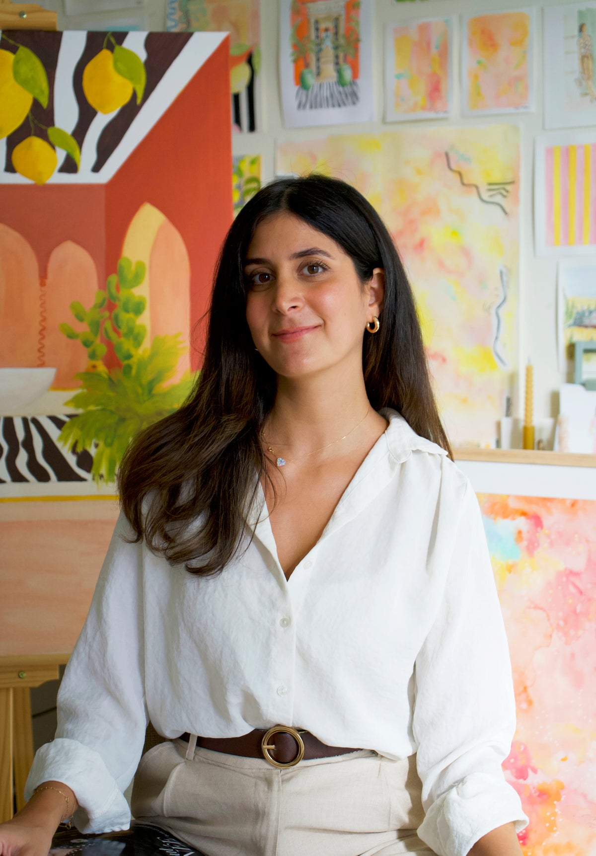 Tanya Hayek in her studio, in front of her paintings