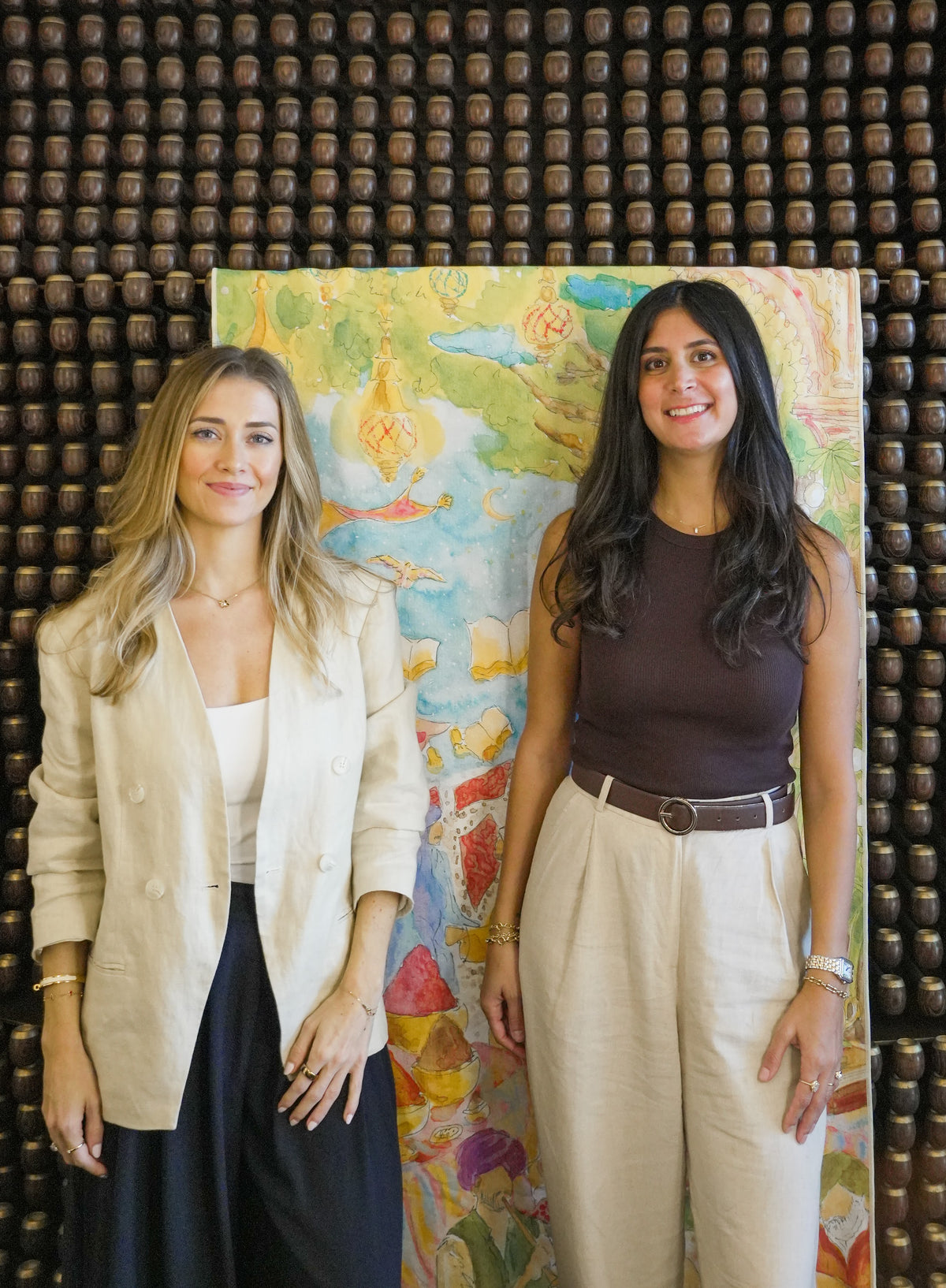 Cristina with artist Tanya Hayek in front of the Mystical Bazaar towel at W Dubai Mina Seyahi