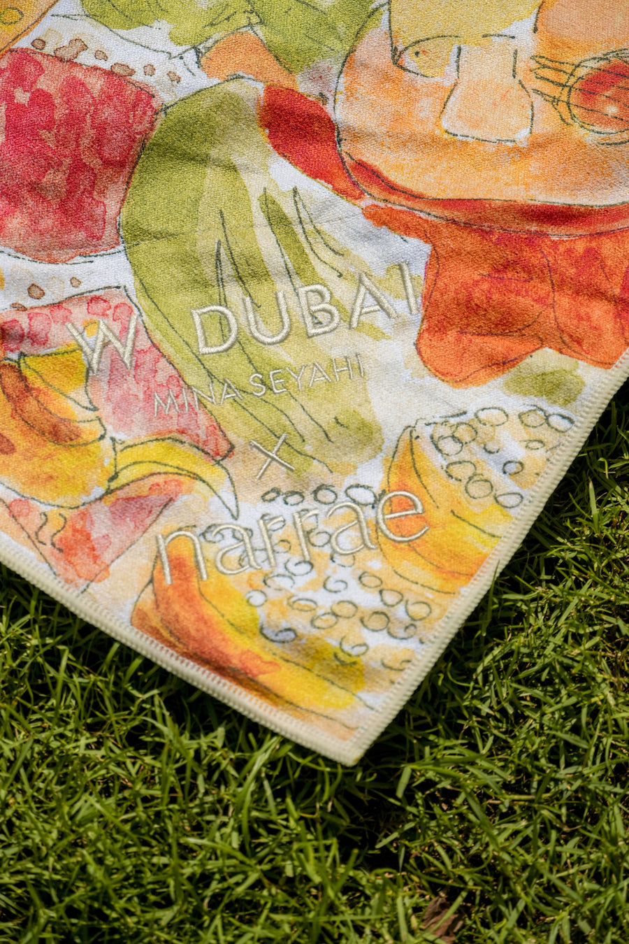 W Dubai Mina Seyahi x narrae logo printed into the corner of the Mystical Bazaar beach towel