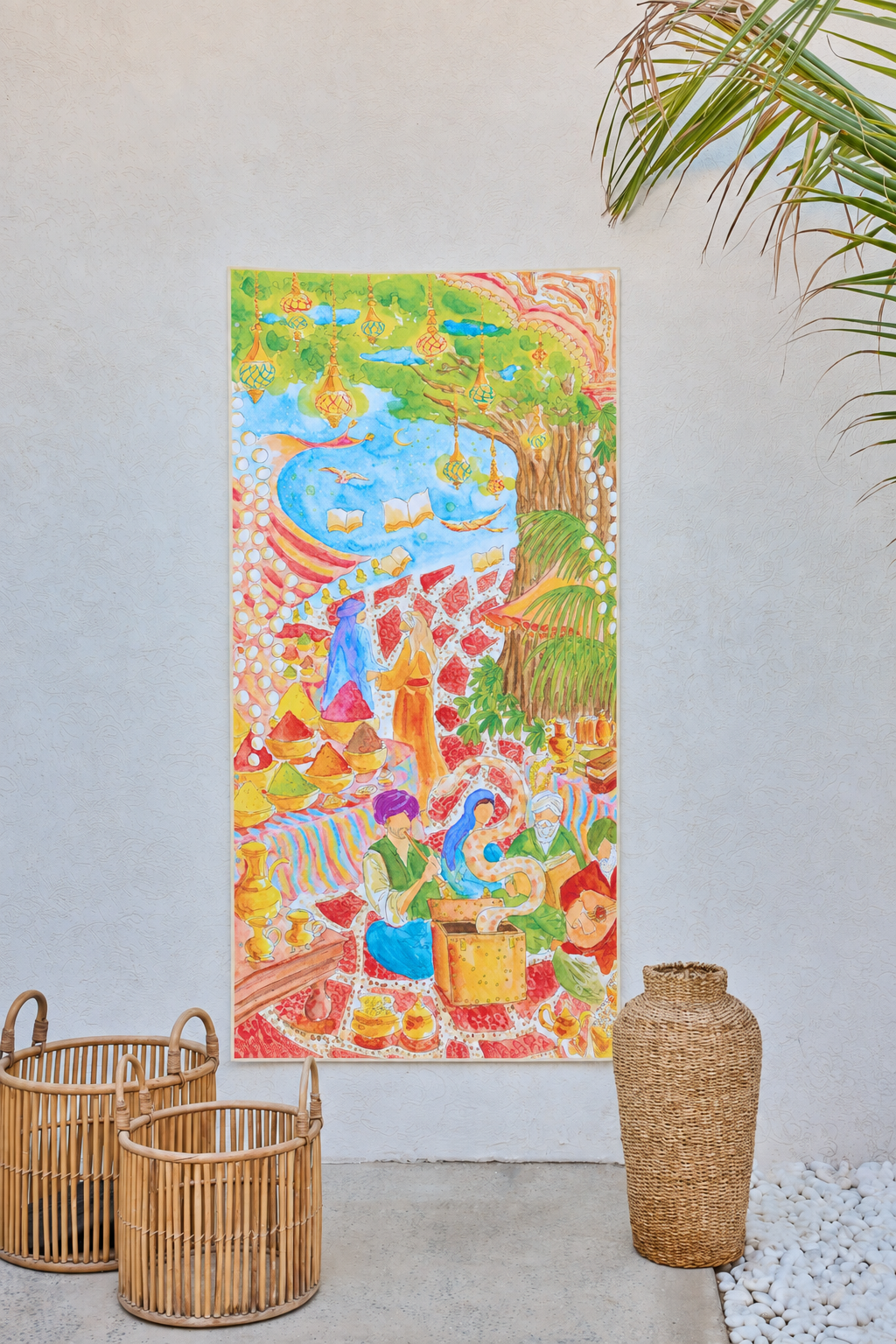 Mystical Bazaar beach towel hung as artwork on a cream wall beside woven baskets
